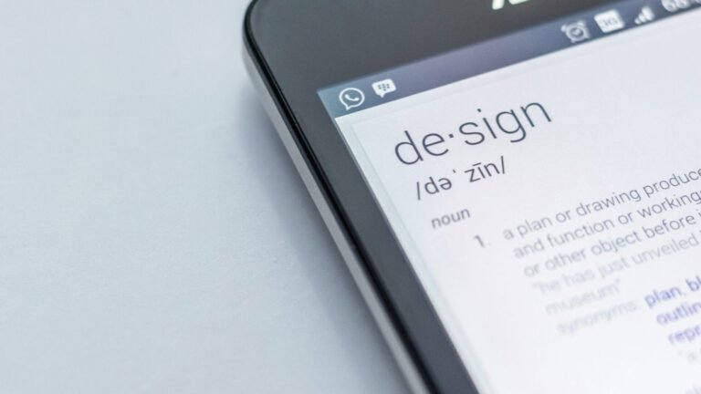 A smart phone showing the word design.